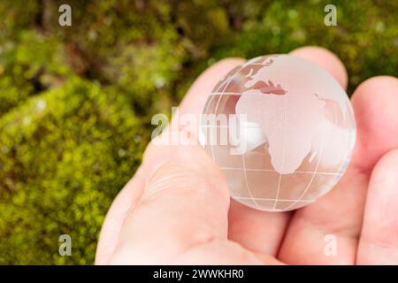 Glass Globe Cradled in Man's Palm, Earth Day and Environmental Conservation Stock Photo