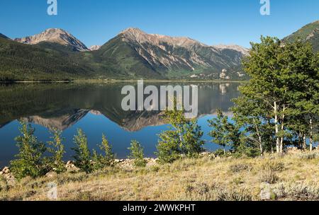Mount Hope and Twin Peaks are reflected on the West Twin Lake in Central Colorado. Located within the San Isabel National Forest Colorado. Stock Photo