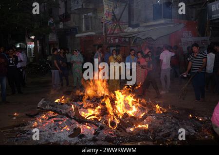 Prayagraj, India. 24th Mar, 2024. People from Hindu community fire the 'Holika' on Sunday night to celebrate Holi festival in district Prayagraj, Uttar Pradesh. Hiranyakashipu's sister, Holika, had a boon granting her immunity to fire. She attempted to trick Prahlad into a pyre, but divine intervention led to her demise while Prahlad emerged unscathed. This event symbolizes the victory of good over evil, a theme central to Holika Dahan. (Photo by Shashi Sharma/Pacific Press) Credit: Pacific Press Media Production Corp./Alamy Live News Stock Photo