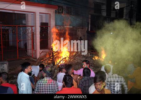 Prayagraj, India. 24th Mar, 2024. People from Hindu community fire the 'Holika' on Sunday night to celebrate Holi festival in district Prayagraj, Uttar Pradesh. Hiranyakashipu's sister, Holika, had a boon granting her immunity to fire. She attempted to trick Prahlad into a pyre, but divine intervention led to her demise while Prahlad emerged unscathed. This event symbolizes the victory of good over evil, a theme central to Holika Dahan. (Photo by Shashi Sharma/Pacific Press) Credit: Pacific Press Media Production Corp./Alamy Live News Stock Photo