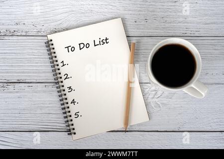 Cup of coffee and To do list text on notepad Stock Photo