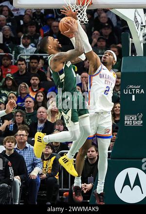 Milwaukee, USA. 24th Mar, 2024. Milwaukee Bucks' Damian Lillard (L) is defended by Oklahoma City Thunder's Shai Gilgeous-Alexander during NBA regular season game between Oklahoma City Thunder and Milwaukee Bucks in Milwaukee, the United States, on March 24, 2024. Credit: Joel Lerner/Xinhua/Alamy Live News Stock Photo