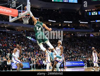 Milwaukee, USA. 24th Mar, 2024. Milwaukee Bucks' Giannis Antetokounmpo (Top) dunks during NBA regular season game between Oklahoma City Thunder and Milwaukee Bucks in Milwaukee, the United States, on March 24, 2024. Credit: Joel Lerner/Xinhua/Alamy Live News Stock Photo