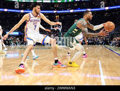 Milwaukee, USA. 24th Mar, 2024. Milwaukee Bucks' Damian Lillard (R) vies with Oklahoma City Thunder's Chet Holmgren during NBA regular season game between Oklahoma City Thunder and Milwaukee Bucks in Milwaukee, the United States, on March 24, 2024. Credit: Joel Lerner/Xinhua/Alamy Live News Stock Photo