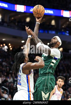 Milwaukee, USA. 24th Mar, 2024. Milwaukee Bucks' Bobby Portis (R) shoots the ball during NBA regular season game between Oklahoma City Thunder and Milwaukee Bucks in Milwaukee, the United States, on March 24, 2024. Credit: Joel Lerner/Xinhua/Alamy Live News Stock Photo