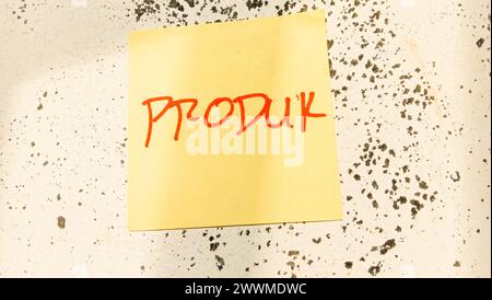 Text with the words "produk" on a note pasted on the wall Stock Photo