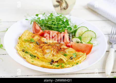 Healthy breakfast.Quesadilla with omelette, bacon  and tomatoes salad. Keto, ketogenic lunch. Stock Photo