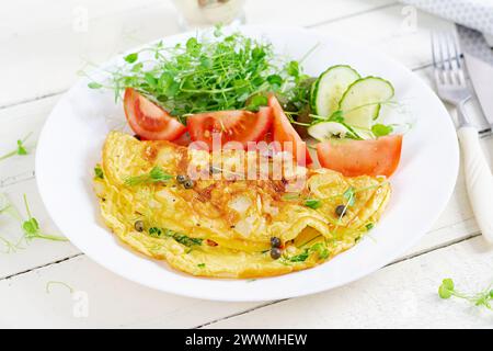 Healthy breakfast.Quesadilla with omelette, bacon  and tomatoes salad. Keto, ketogenic lunch. Stock Photo