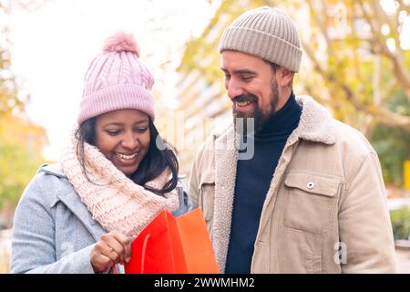 Happy young couple outdoors looking shopping Stock Photo