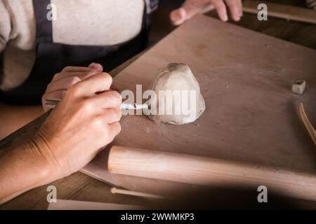 Handmade Ceramics: Children's Hands Close-Up in Clay Modeling. Stock Photo