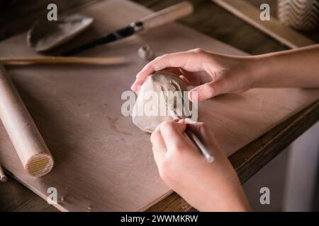 Handmade Clay Creations: Children's Hands in Ceramics Close-Up. Stock Photo