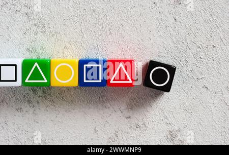 Geometrical shapes on colorful cubes in same sequence pattern. Logic, order, pattern and IQ test concepts. Stock Photo