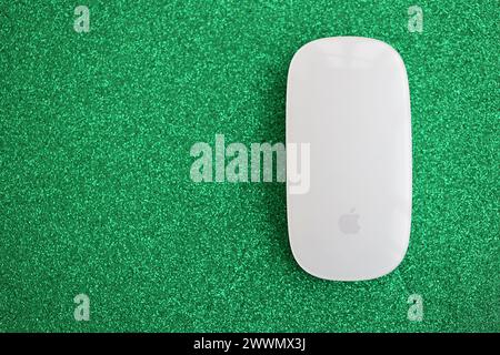KYIV, UKRAINE - NOVEMBER 27, 2023 Apple Magic Mouse 3rd generation lies on sparkling glitter surface close up Stock Photo