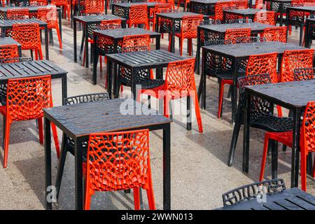 Empty black tables and red wrought iron chairs, outside a restaurant in George Square, Glasgow, Scotland, UK Stock Photo