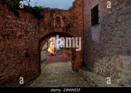 Gate and street in the old town, night view. San Vicente de la Barquera, Cantabria, Spain. Stock Photo