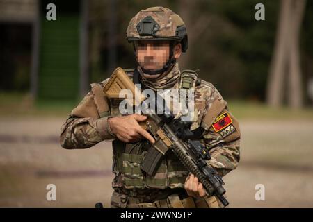 An Albanian special operations forces soldier ducks behind a wooden ...