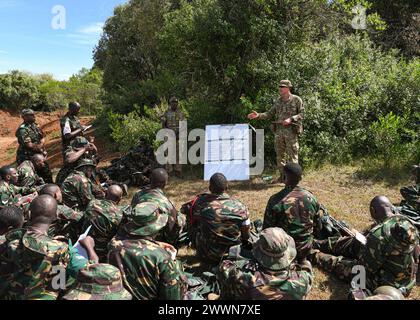 British army Capt. Hugo Brewer, an army officer assigned to 1st Battalion Irish Guards, 11th Security Force Assistance Brigade, trains Tanzania service members on ground sign awareness for counter improvised explosive devices during Justified Accord 2024 (JA24) held at the Counter Insurgency Terrorism and Stability Operations (CITSO) Training Centre, Nanyuki, Kenya, February 26, 2024. The British army's 11th Security Force Assistance Brigade is leading urban operations, counter improvised explosive device and small unmanned aircraft systems training during the multinational field training held Stock Photo