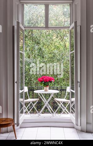 View through open French doors to balcony of modern West London apartment, UK Stock Photo