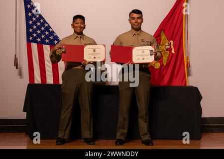 US. Marine Corps Sgt. Robin Alejandro Mendoza, left, a chief combat marksmanship coaches course instructor, with Weapons and Field Training Battalion and Sgt. Ceaser Verdin, a drill instructor with Support Training Battalion, Marine Corps Recruit Depot San Diego, pose with certificates and medals they earned at the Marine Corps Marksmanship Competition West at Marine Corps Base Camp Pendleton, California, Feb. 23, 2024. Mendoza, a native of Auburn, Washington, and Verdin, a native of Pomona, California, are members of the Edson Range shooting team. The MCMC West was held in conjunction with se Stock Photo