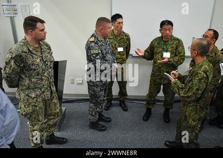 Lt. Gen. TAKEMOTO Ryoji, commanding general of the Ground Component Command, Japan Ground Self-Defense Force, speaks with JGSDF, United States Forces Japan and Australian Defence Force personnel during his visit to the the Bilateral Joint Operations Coordination Center during Exercise Keen Edge 24 on Yokota Air Base, Japan, Feb. 4, 2024. TAKEMOTO met with BJOCC personnel from Japan, the U.S. and Australia and received an update brief about the exercise’s progress. Keen Edge allows the U.S. and Japan to practice coordination procedures and improve interoperability to effectively respond to any Stock Photo