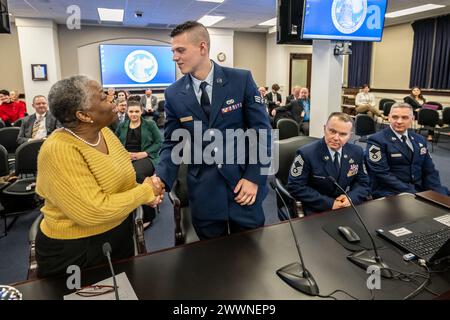 Retired Air Force colonel and State Rep. Pamela Stevenson, left, congratulates Senior Airman Ethan Hall during the Kentucky General Assembly’s Interim Joint Committee on Veterans, Military Affairs and Public Protection meeting at the state Capitol in Frankfort, Ky., Feb. 13, 2024. Hall, a C-130J Super Hercules crew chief for the Kentucky Air National Guard’s 123rd Aircraft Maintenance Squadron, was recognized for exceptional performance. Joining him at the meeting were, left to right, his unit’s senior enlisted leader, Chief Master Sgt. Chad Chamberlain; and the squadron superintendent, Senior Stock Photo
