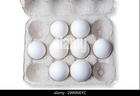 White eggs in a carton box on white background. Top view. Stock Photo