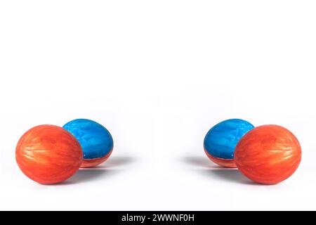 Red and blue painted easter eggs isolated on white background with copy space. Easter concept. Stock Photo