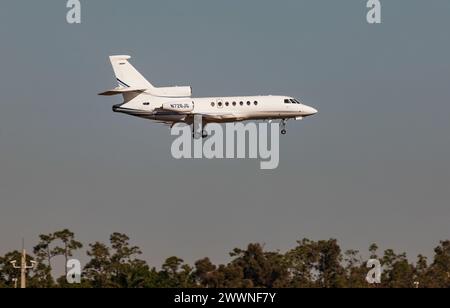 FORT MYERS, FLORIDA, USA - 27 FEB 2024. Private luxury jet Dassault Falcon 50EX landing at Southwest Florida International Airport (RSW) USA on a sunn Stock Photo