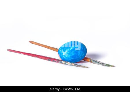 Colorful painted Easter eggs and paint brush on white background with copy space Stock Photo