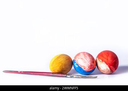 Colorful painted Easter eggs and paint brush on white background Stock Photo