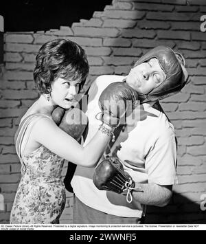 Actress Lill-Babs Svensson during filming of the Swedish feature film Svenska Floyd, where Lill-babs plays the singer and beauty Lollo Fillipini and Carl-Gustaf Lindstedt as the boxer Flosse, alias Svenska Floyd from Nockeby. She can be seen in the picture landing an uppercut on his chin. 1961 Kristoffersson ref CS14-6 Stock Photo