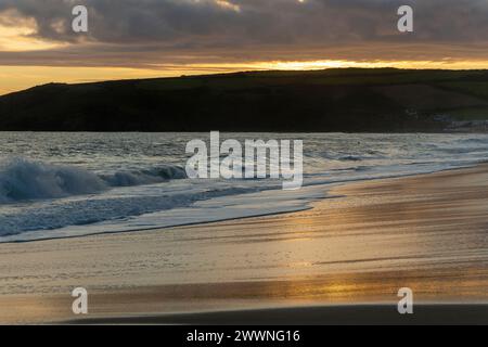 Evening Light, View Looking Across Praa Sands in Cornwall Towards Sydney Cove and Hoe Point with Golden Light on Wet Sand with Waves Stock Photo