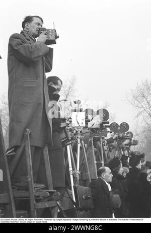 Press photographers. Media is very interested in covering the funeral of King George VI (1895-1952). The funeral took place at St Geroge's Chapel Windsor Castle on the 15th of February 1952. The photographers are seen standing on ladders to get a better view. Stock Photo