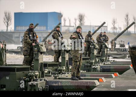 Photo Description:  German soldiers on top of an amphibious rig during an exercise, in Poland on March 2, 2024.  Exercise Background:  During Exercise Dragon-24 (DR-24) in Poland, NATO will test the Polish Armed Forces' response to potential crises, involving around 20,000 soldiers and 3,500 units of equipment from 9 NATO countries. The participants include: Poland; France; Germany; Lithuania;  Slovenia; Spain; Türkiye; United Kingdom and USA. The exercise will evaluate their ability to execute combat tasks across various domains, including land, air, sea, and cyberspace. It will include eleme Stock Photo