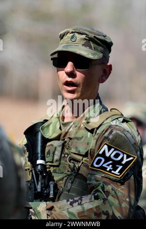 Tennessee Army National Guardsman Staff Sgt. Christopher Thomas, from the 117th Regional Training Institute, receives instruction before completing the 'react to IED event' during the Tennessee State Best Warrior Competition, in Tullahoma, Feb. 23, 2024. This event provides foundational knowledge about IEDs and proper safety precautions and procedures for reacting and responding to unattended and suspicious items.  Army National Guard Stock Photo