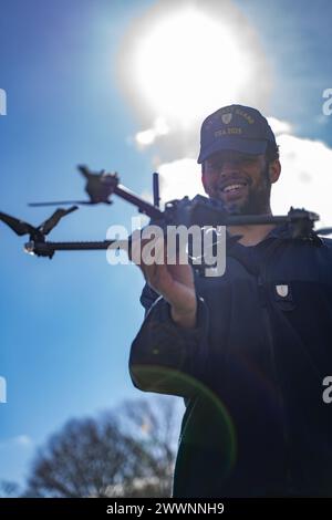 A cadet holds up a drone during a training course at the Coast Guard Academy, New London, Conn, Feb 21, 2023. The Coast Guard Short Ranged Unmanned Aerial Systems (SR-UAS) program is designed to create designated pilots and integrate drone capabilities into various missions.  Coast Guard photograph by Petty Officer 3rd Class Matt Thieme) Stock Photo