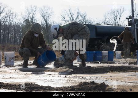 U.S. Navy Sailors assigned to Naval Mobile Construction Battalion 1 repair a crater on the airfield’s tarmac during Exercise Winter Pioneer 24, Marine Corps Outlying Field Oak Grove, North Carolina, Feb. 15, 2024. U.S. Marine Corps engineers and U.S. Navy construction force utilized Marine Corps Outlying Field Oak Grove for Marines and Sailors to rehearse establishing and sustaining advanced naval and expeditionary bases that contribute to maritime domain awareness.  Marine Corps Stock Photo