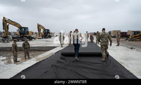 Airmen of the 8th Civil Engineer, Kunsan Air Base Republic of Korea and the 554th Red Horse Squadron from Andersen Air Force Base, Guam measure strips of geotarp in preparation for airfield repair at Kunsan AB, ROK, Feb. 13, 2024. Geotarps are used as layers of separation from existing rubble and added filament to ensure an even surface when conducting airfield repairs.  Air Force Stock Photo