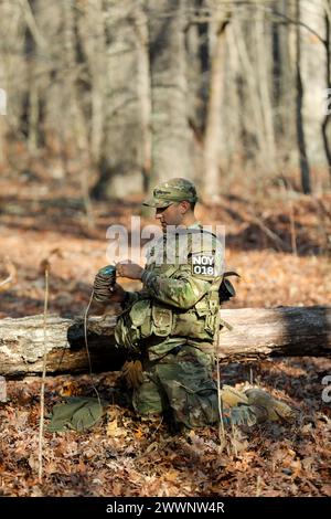 Tennessee Army National Guardsman Staff Sgt. Daniel Vasquez, from the 30th Troop Command, retrieves a practice claymore during the Tennessee State Best Warrior Competition in Tullahoma, Feb. 23, 2024. The claymore is a command-detonated fragmentation weapon designed primarily for use against personnel.  Army National Guard Stock Photo