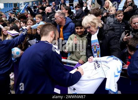 Coventry City's Liam Kelly signs a fans shirt after a training session at the Coventry Building Society Arena, Coventry. Picture date: Monday March 25, 2024. Stock Photo