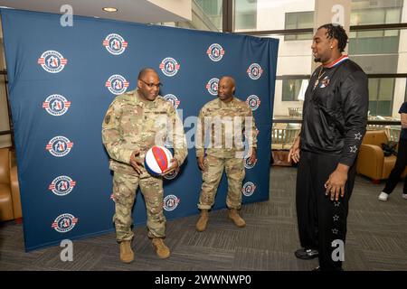 With the faint sound of “Sweet Georgia Brown” playing in the background, Two members of the Harlem Globetrotters stopped by Naval Support Activity Bethesda (NSAB), home to Walter Reed National Military Medical Center, on Feb. 12 to spread some cheer and share a little bit of their basketball prowess with patients, their families, and staff on base. Harlem Globetrotters Justin “X-Over” Tompkins and Joey “Hot Rod” De La Rosa signed autographs, gave out souvenirs, and showed off their ballhandling skills to those who came by Building 62’s Warrior Cafe on NSAB/Walter Reed to see them.   Tompkins, Stock Photo