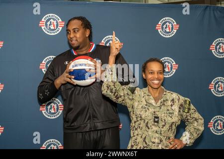 With the faint sound of “Sweet Georgia Brown” playing in the background, Two members of the Harlem Globetrotters stopped by Naval Support Activity Bethesda (NSAB), home to Walter Reed National Military Medical Center, on Feb. 12 to spread some cheer and share a little bit of their basketball prowess with patients, their families, and staff on base. Harlem Globetrotters Justin “X-Over” Tompkins and Joey “Hot Rod” De La Rosa signed autographs, gave out souvenirs, and showed off their ballhandling skills to those who came by Building 62’s Warrior Cafe on NSAB/Walter Reed to see them.   Tompkins, Stock Photo