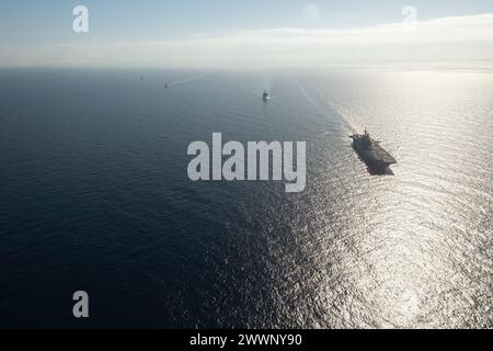240206-N-AB188-1236 MEDITERRANEAN SEA (Feb. 6, 2024) The Wasp-class amphibious assault ship USS Bataan (LHD 5) and the Harpers Ferry-class dock landing ship USS Carter Hall (LSD 50) transit in formation with the Turkish frigates TCG Gaziantep (F-490) and the TCG Gemlik (F-492) in the Mediterranean Sea, Feb. 6. Bataan and Carter Hall are on a scheduled deployment in the U.S. Naval Forces Europe area of operations, employed by U.S. Sixth Fleet to defend U.S., allied and partner interests.  Navy Stock Photo