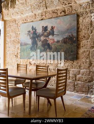 Vintage chairs at table with artwork in luxury apartment in Beirut, Lebanon. Stock Photo