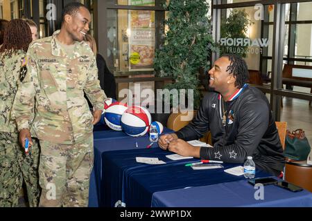 With the faint sound of “Sweet Georgia Brown” playing in the background, Two members of the Harlem Globetrotters stopped by Naval Support Activity Bethesda (NSAB), home to Walter Reed National Military Medical Center, on Feb. 12 to spread some cheer and share a little bit of their basketball prowess with patients, their families, and staff on base. Harlem Globetrotters Justin “X-Over” Tompkins and Joey “Hot Rod” De La Rosa signed autographs, gave out souvenirs, and showed off their ballhandling skills to those who came by Building 62’s Warrior Cafe on NSAB/Walter Reed to see them.   Tompkins, Stock Photo