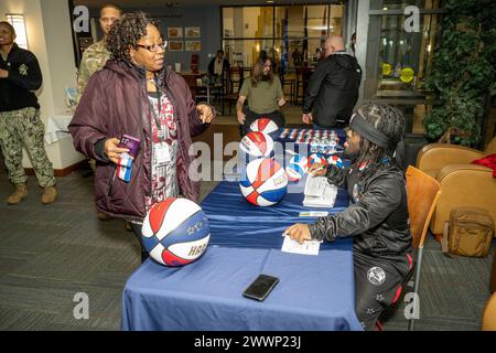 With the faint sound of “Sweet Georgia Brown” playing in the background, Two members of the Harlem Globetrotters stopped by Naval Support Activity Bethesda (NSAB), home to Walter Reed National Military Medical Center, on Feb. 12 to spread some cheer and share a little bit of their basketball prowess with patients, their families, and staff on base. Harlem Globetrotters Justin “X-Over” Tompkins and Joey “Hot Rod” De La Rosa signed autographs, gave out souvenirs, and showed off their ballhandling skills to those who came by Building 62’s Warrior Cafe on NSAB/Walter Reed to see them.   Tompkins, Stock Photo