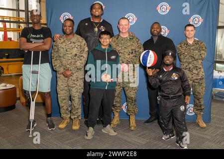 With the faint sound of “Sweet Georgia Brown” playing in the background, Two members of the Harlem Globetrotters stopped by Naval Support Activity Bethesda (NSAB), home to Walter Reed National Military Medical Center, on Feb. 12 to spread some cheer and share a little bit of their basketball prowess with patients, their families, and staff on base. Harlem Globetrotters Justin “X-Over” Tompkins and Joey “Hot Rod” De La Rosa signed autographs, gave out souvenirs, and showed off their ballhandling skills to those who came by Building 62’s Warrior Cafe on NSAB/Walter Reed to see them.   Tompkins, Stock Photo