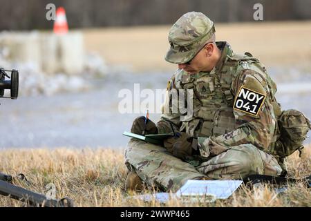 Tennessee Army National Guardsman Staff Sgt. Christopher Thomas, from the 117th Regional Training Institute, develops a range card during the Tennessee State Best Warrior Competition, in Tullahoma, Feb. 23, 2024. A range card aids in planning and controlling fires and aids the crews and squad gunners in acquiring targets during limited visibility.  Army National Guard Stock Photo