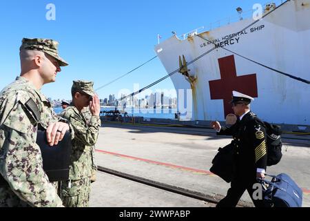 Rear Adm. Guido Valdes, director of the Defense Health Network Pacific Rim (DHNPR) and Commander, Naval Medical Forces Pacific, salutes a crew member returning from deployment aboard USNS Mercy (T-AH 19). Mercy returned to its homeport in San Diego after a four-month deployment in support of Pacific Partnership 2024. Pacific Partnership is the largest annual multinational humanitarian assistance and disaster relief preparedness mission conducted in the Indo-Pacific area of operations. Engagements between USNS Mercy’s crew and host nations ensure the international community is better prepared t Stock Photo