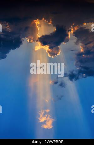 Sunlight shining through the dark clouds Stock Photo
